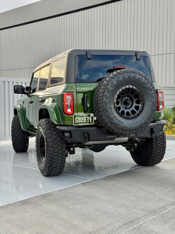 Green Ford Bronco rear with spare tire and Rough Country bumper