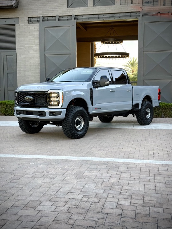Gray Ford F-250 lifted in golden evening light